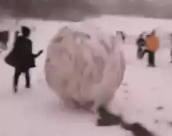 Playing with a giant snow ball
